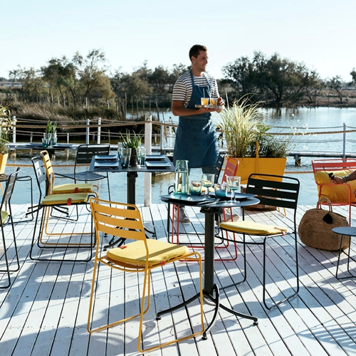 Sillas Surprising en una terraza de exterior de un restaurante frenta a un rio